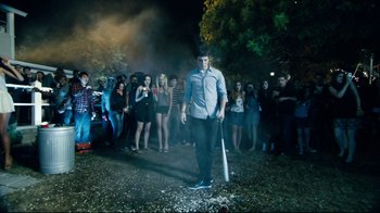 Movie still from “Project X” (2012), directed by Nima Nourizadeh – A man holding a baseball bat in front of a group of people; Wide shot, High angle