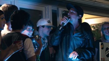 Movie still from “Project X” (2012), directed by Nima Nourizadeh – A group of young men standing next to each other holding microphones; Medium shot, Low angle