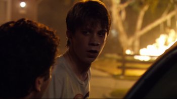 Movie still from “Project X” (2012), directed by Nima Nourizadeh – A young man standing on the side of a road; Close Up shot, Over the shoulder angle
