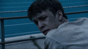 Movie still from “Project X” (2012), directed by Nima Nourizadeh – A young man is looking down at the ground; Close Up shot, High angle