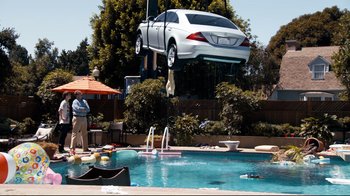 Movie still from “Project X” (2012), directed by Nima Nourizadeh – A white car is in the air over a pool; Extreme Wide shot, Low angle