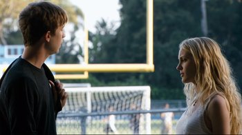 Movie still from “Project X” (2012), directed by Nima Nourizadeh – Two young people standing next to each other on a football field; Medium shot, Over the shoulder angle