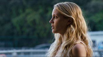 Movie still from “Project X” (2012), directed by Nima Nourizadeh – A beautiful blond woman with long blonde hair looking to the side; Close Up shot, Over the shoulder angle