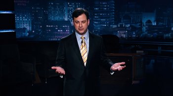 Movie still from “Project X” (2012), directed by Nima Nourizadeh – A man wearing a suit and tie in front of a tv; Medium shot, Low angle