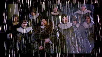 Movie still from “Prospero's Books” (1991), directed by Peter Greenaway – A group of people dressed in medieval clothing; Wide shot, Low angle