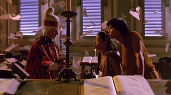 Movie still from “Prospero's Books” (1991), directed by Peter Greenaway – Three people standing in front of a candle holder; Medium shot, Low angle