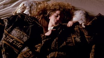 Movie still from “Prospero's Books” (1991), directed by Peter Greenaway – A woman laying in a bed with her eyes closed; Medium shot, Overhead angle