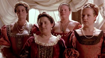 Movie still from “Prospero's Books” (1991), directed by Peter Greenaway – A group of women dressed in medieval clothing; Medium shot, Low angle
