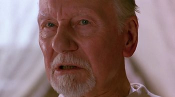 Movie still from “Prospero's Books” (1991), directed by Peter Greenaway – An old man with a beard and mustache looking to his left; Close Up shot, Over the shoulder angle