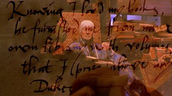 Movie still from “Prospero's Books” (1991), directed by Peter Greenaway – An image of an old man holding a book; Close Up shot, High angle