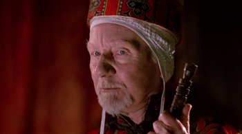 Movie still from “Prospero's Books” (1991), directed by Peter Greenaway – An old man wearing a hat and holding something in his hand; Close Up shot, Low angle