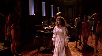 Movie still from “Prospero's Books” (1991), directed by Peter Greenaway – A woman in a white dress standing in front of a piano; Wide shot, High angle