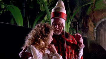 Movie still from “Prospero's Books” (1991), directed by Peter Greenaway – An older man and a young girl in a costume; Medium shot, Over the shoulder angle