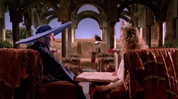 Movie still from “Prospero's Books” (1991), directed by Peter Greenaway – Two people sitting in chairs in front of an altar; Wide shot, Over the shoulder angle