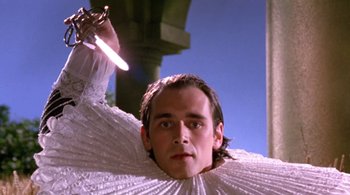 Movie still from “Prospero's Books” (1991), directed by Peter Greenaway – A person holding a sword; Close Up shot, Low angle