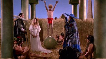 Movie still from “Prospero's Books” (1991), directed by Peter Greenaway – A group of people standing in a field; Wide shot, Low angle