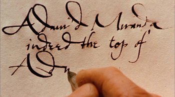 Movie still from “Prospero's Books” (1991), directed by Peter Greenaway – A person writing on a piece of paper; Extreme Close Up shot, Overhead angle
