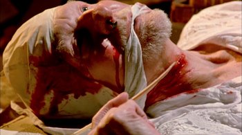 Movie still from “Prospero's Books” (1991), directed by Peter Greenaway – An old man with blood on his face and head; Extreme Close Up shot, Overhead angle