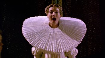 Movie still from “Prospero's Books” (1991), directed by Peter Greenaway – A woman in a white dress with a large white collar; Close Up shot, Low angle