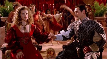 Movie still from “Prospero's Books” (1991), directed by Peter Greenaway – A group of people in costumes dancing in a room; Medium shot, High angle