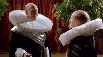 Movie still from “Prospero's Books” (1991), directed by Peter Greenaway – Two men in elizabethan garb looking at each other; Medium shot, Over the shoulder angle