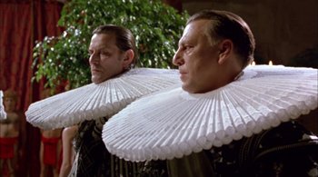 Movie still from “Prospero's Books” (1991), directed by Peter Greenaway – A couple of men standing next to each other; Close Up shot, Low angle
