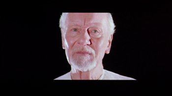 Movie still from “Prospero's Books” (1991), directed by Peter Greenaway – An old man with a white beard is looking at the camera; Close Up shot, Low angle