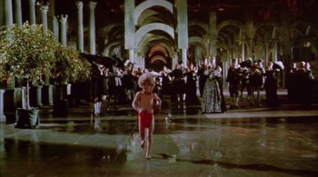 Movie still from “Prospero's Books” (1991), directed by Peter Greenaway – A young child running in a large room; Extreme Wide shot, High angle