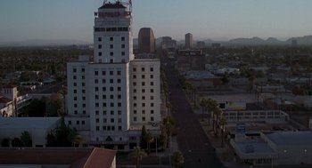 Movie still from “Psycho” (1998), directed by Gus Van Sant – An aerial view of a city street and buildings; Extreme Wide shot, High angle