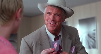 Movie still from “Psycho” (1998), directed by Gus Van Sant – An older man wearing a suit and a hat holding a picture; Close Up shot, Over the shoulder angle