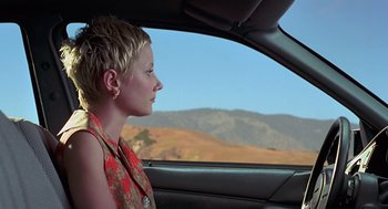 Movie still from “Psycho” (1998), directed by Gus Van Sant – A woman sitting in the driver's seat of a car looking out the window; Close Up shot, Low angle