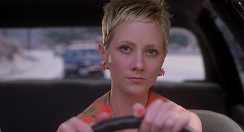 Movie still from “Psycho” (1998), directed by Gus Van Sant – A woman with short blonde hair is holding a steering wheel; Close Up shot, Over the shoulder angle
