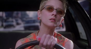 Movie still from “Psycho” (1998), directed by Gus Van Sant – A woman wearing sunglasses is holding the steering wheel of a car; Close Up shot, Low angle