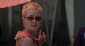 Movie still from “Psycho” (1998), directed by Gus Van Sant – A woman with sunglasses and an orange umbrella; Close Up shot, Low angle
