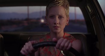 Movie still from “Psycho” (1998), directed by Gus Van Sant – A woman sitting in the drivers seat of a car holding a steering wheel; Close Up shot, Over the shoulder angle