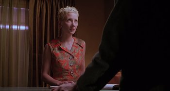 Movie still from “Psycho” (1998), directed by Gus Van Sant – A woman with short blonde hair sitting at a table with a man; Close Up shot, Over the shoulder angle