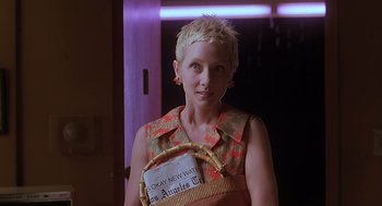 Movie still from “Psycho” (1998), directed by Gus Van Sant – A woman holding a sign that says " okay new white los angeles city "; Close Up shot, Over the shoulder angle