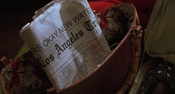 Movie still from “Psycho” (1998), directed by Gus Van Sant – A newspaper sitting inside of a purse; Extreme Close Up shot, High angle