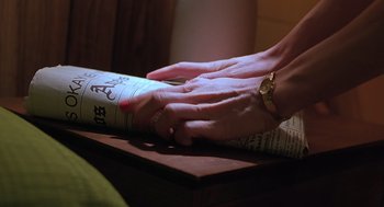 Movie still from “Psycho” (1998), directed by Gus Van Sant – A woman's hands are on top of an open book; Extreme Close Up shot, High angle