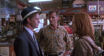 Movie still from “Psycho” (1998), directed by Gus Van Sant – Two men and a woman standing in a store talking; Medium shot, Over the shoulder angle