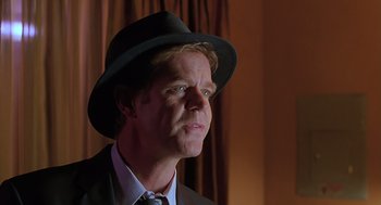 Movie still from “Psycho” (1998), directed by Gus Van Sant – A man wearing a suit and a hat looking to his left; Close Up shot, Over the shoulder angle