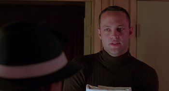 Movie still from “Psycho” (1998), directed by Gus Van Sant – A man in a brown sweater and a black hat; Close Up shot, Over the shoulder angle