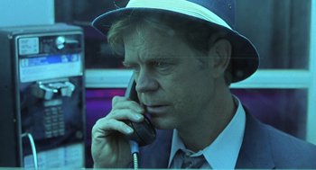Movie still from “Psycho” (1998), directed by Gus Van Sant – A man wearing a hat talking on a cell phone; Close Up shot, Low angle
