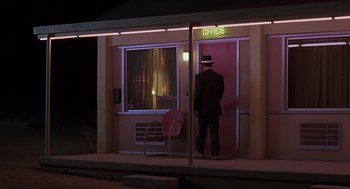 Movie still from “Psycho” (1998), directed by Gus Van Sant – A man standing in front of an office door at night; Wide shot, Low angle