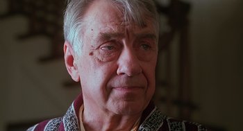 Movie still from “Psycho” (1998), directed by Gus Van Sant – An older man with white hair looking at the camera; Close Up shot, Low angle