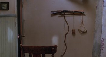 Movie still from “Psycho” (1998), directed by Gus Van Sant – A wooden chair sitting in a room next to a wall; Extreme Close Up shot, High angle
