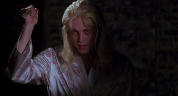 Movie still from “Psycho” (1998), directed by Gus Van Sant – A man with long blonde hair wearing a robe; Close Up shot, Low angle