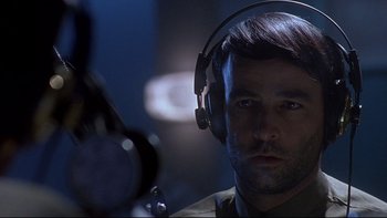 Movie still from “Psycho IV: The Beginning” (1990), directed by Mick Garris – A person wearing headphones; Close Up shot, Low angle