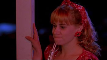 Movie still from “Psycho IV: The Beginning” (1990), directed by Mick Garris – A woman in a red dress holding a fork; Close Up shot, Low angle