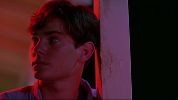 Movie still from “Psycho IV: The Beginning” (1990), directed by Mick Garris – A young man is looking into the distance; Close Up shot, Low angle